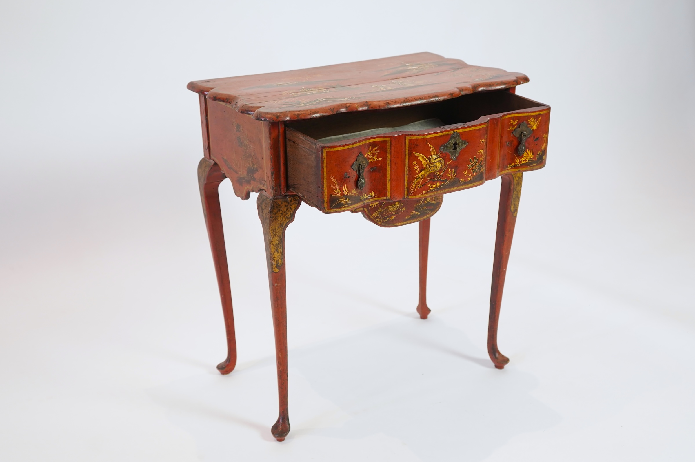 An early 18th century scarlet japanned lowboy